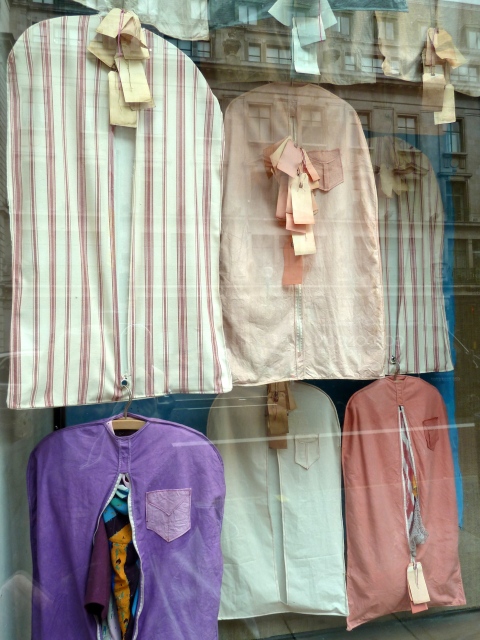 Close up detail, vintage look garment bags in Anthropologie windows