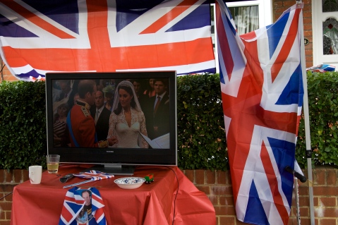 The Royal Wedding is replayed at on a street party television.