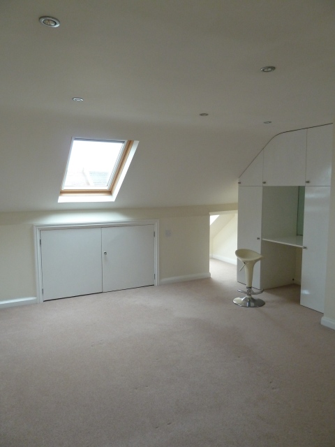 The loft conversion with magnolia walls and that same pink carpet